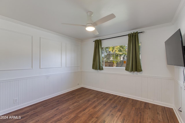 empty room featuring ornamental molding, dark hardwood / wood-style floors, and ceiling fan