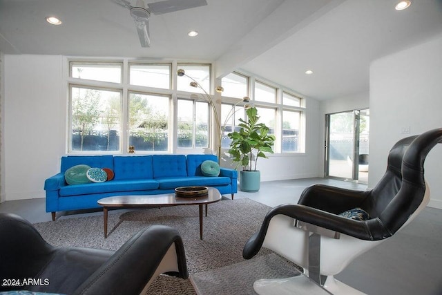 living room featuring ceiling fan and lofted ceiling with beams