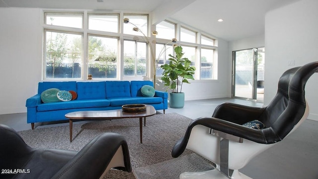 sunroom featuring lofted ceiling with beams and a healthy amount of sunlight