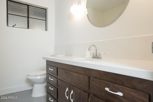 bathroom featuring toilet and vanity