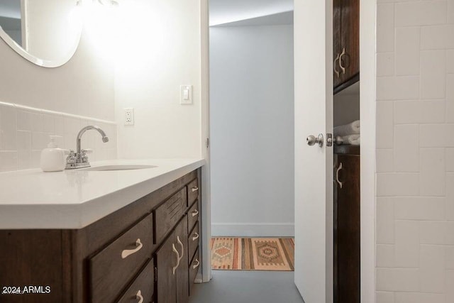 bathroom with vanity and decorative backsplash