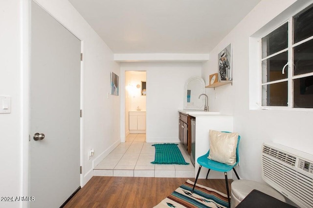 living area with light hardwood / wood-style floors and sink