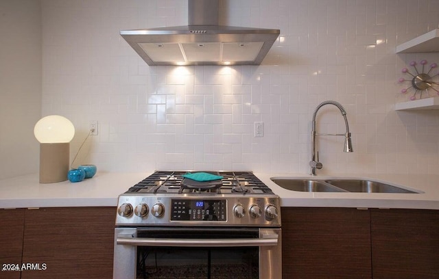 kitchen featuring island exhaust hood, backsplash, dark brown cabinetry, sink, and high end stainless steel range oven