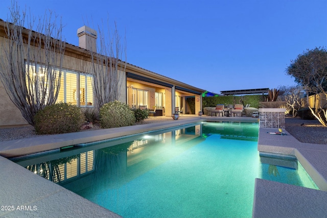 view of pool at dusk