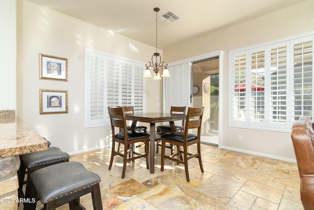 dining room with a notable chandelier