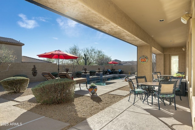 view of patio with a fenced in pool