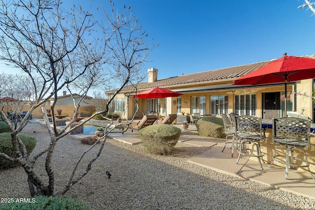 rear view of house featuring a patio