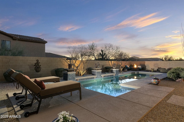 pool at dusk with a patio