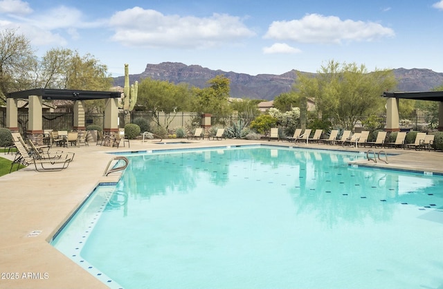 view of swimming pool with a mountain view and a patio area