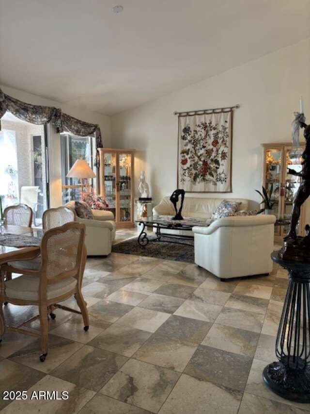 living area with vaulted ceiling and plenty of natural light