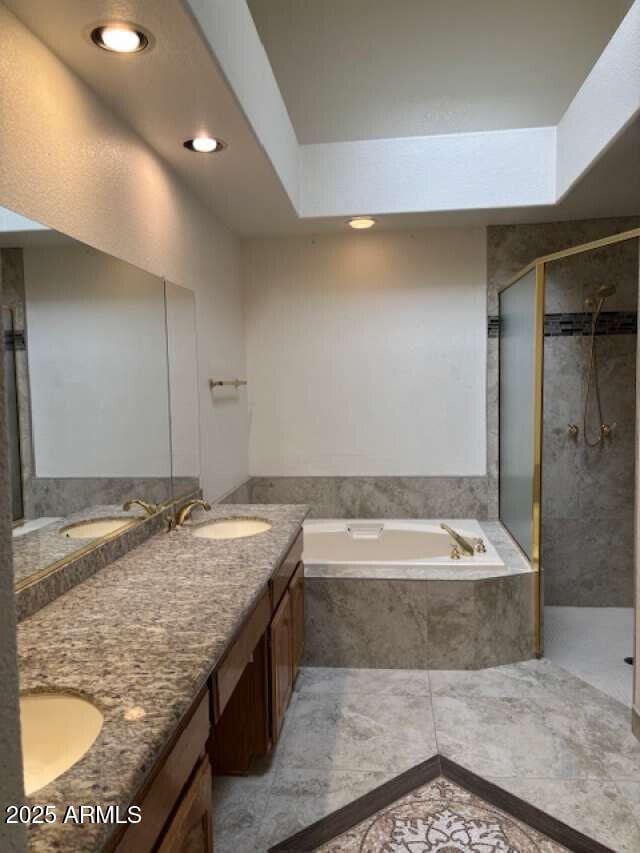 full bathroom with a bath, a stall shower, double vanity, and recessed lighting