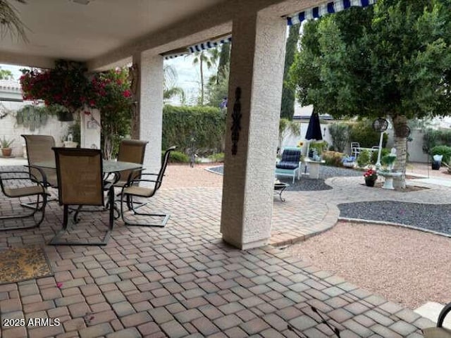 view of patio featuring a fenced backyard and outdoor dining area