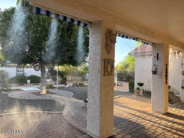 view of patio featuring fence