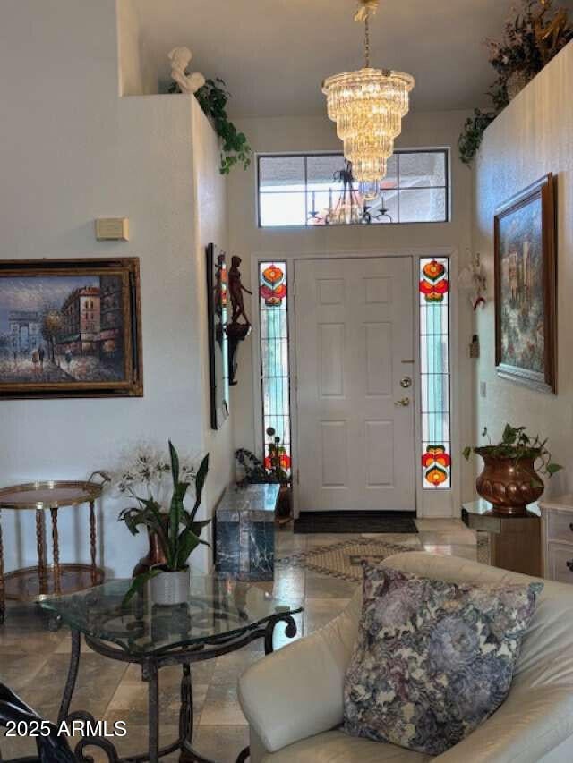 foyer with a chandelier