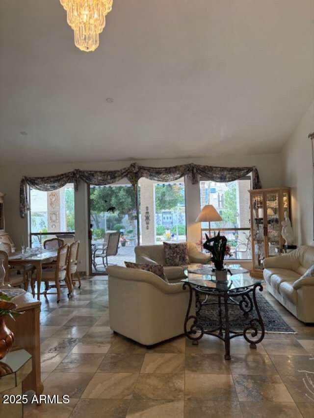 living room featuring plenty of natural light and a chandelier