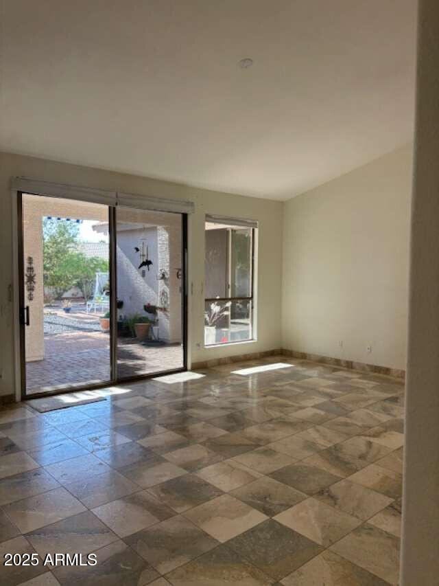 spare room with baseboards