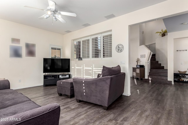 living room featuring wood finished floors, a ceiling fan, stairway, and baseboards
