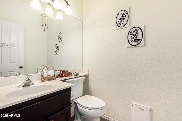 half bathroom featuring toilet and vanity