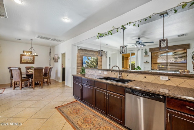 kitchen featuring backsplash, ceiling fan with notable chandelier, sink, decorative light fixtures, and dishwasher