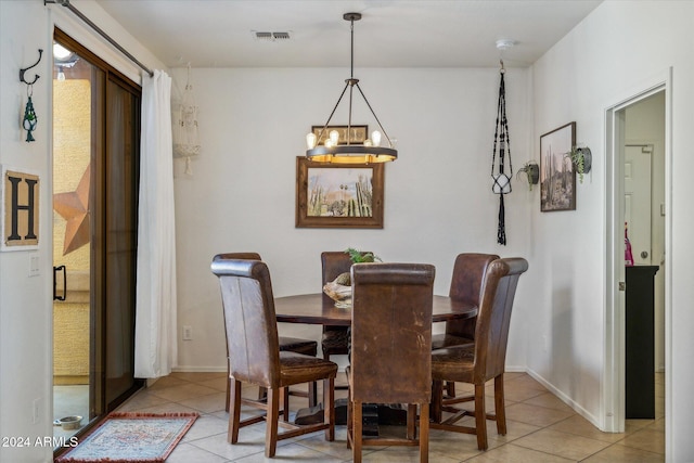 dining area featuring a notable chandelier and light tile patterned floors