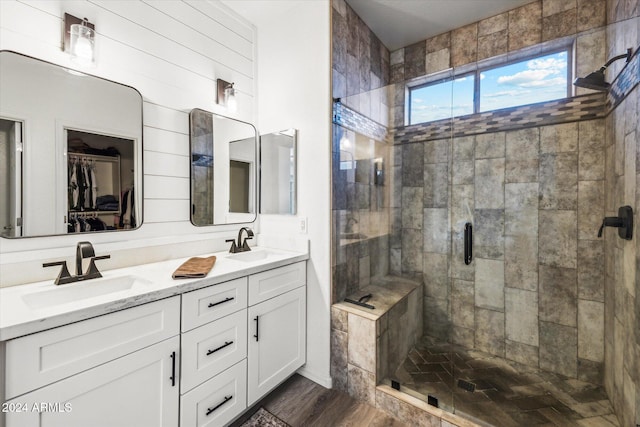 bathroom featuring hardwood / wood-style floors, vanity, and walk in shower