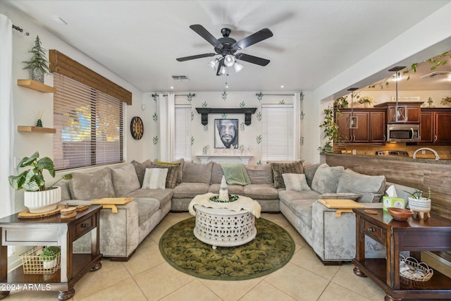 living room with ceiling fan and light tile patterned floors