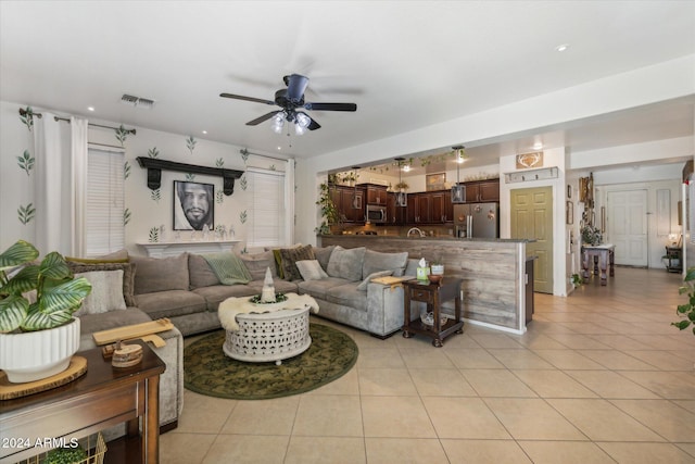 living room with light tile patterned floors and ceiling fan