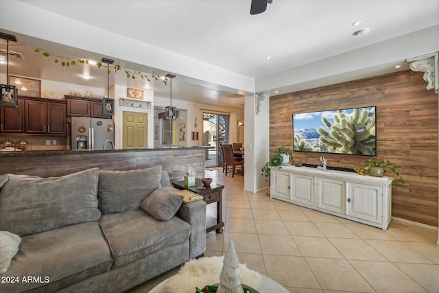 tiled living room featuring wood walls