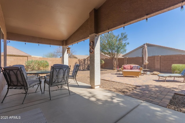 view of patio featuring outdoor dining space, a fenced backyard, and an outdoor hangout area