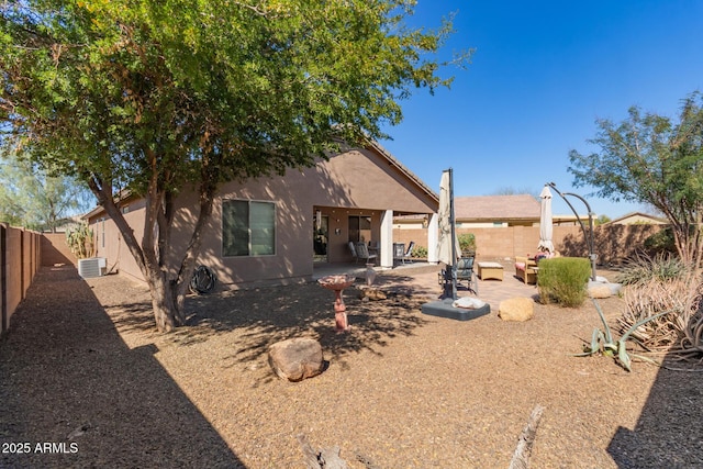 back of property featuring a fenced backyard, cooling unit, a patio, and stucco siding