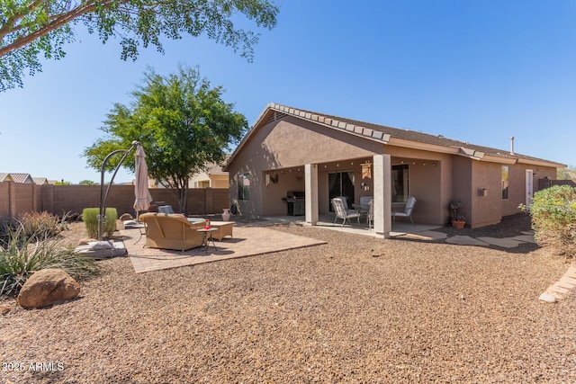 back of house with stucco siding, fence, and a patio