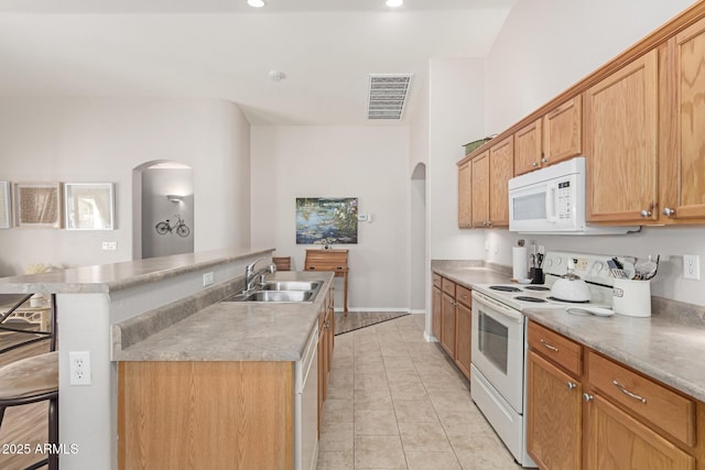 kitchen featuring arched walkways, light tile patterned floors, visible vents, a sink, and white appliances