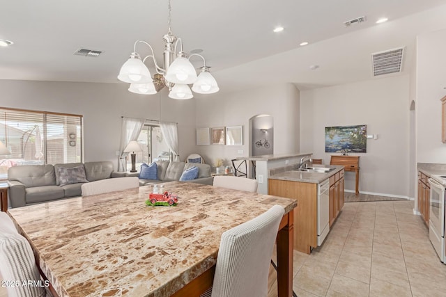 dining room featuring light tile patterned floors, arched walkways, and visible vents