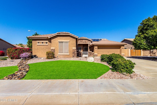 view of front facade with driveway, stucco siding, a front lawn, a tiled roof, and roof mounted solar panels