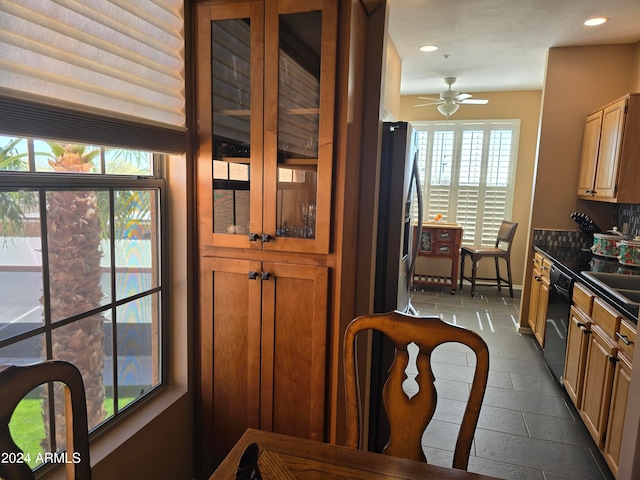 kitchen featuring stainless steel fridge, dark tile floors, ceiling fan, sink, and dishwasher