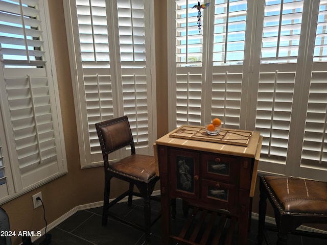 dining room featuring dark tile floors