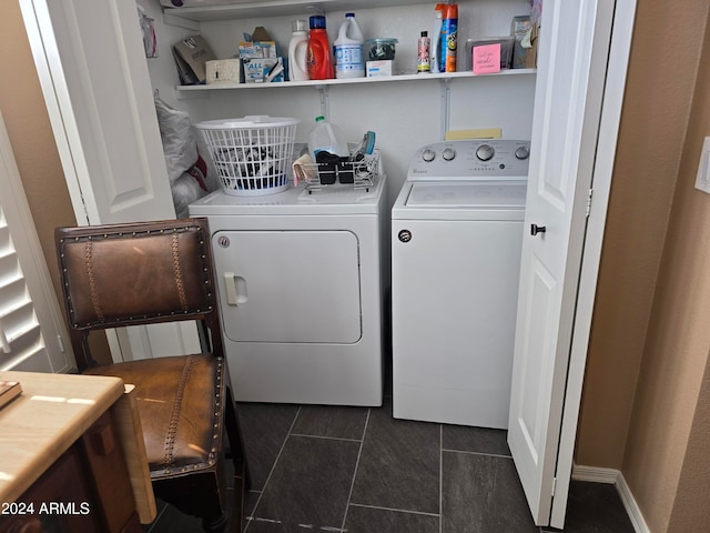 laundry area featuring washer and dryer and dark tile floors