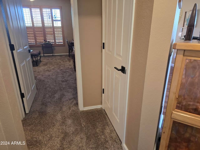 corridor with dark colored carpet