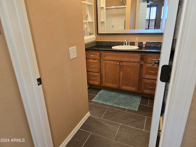 bathroom featuring vanity, ceiling fan, and tile flooring