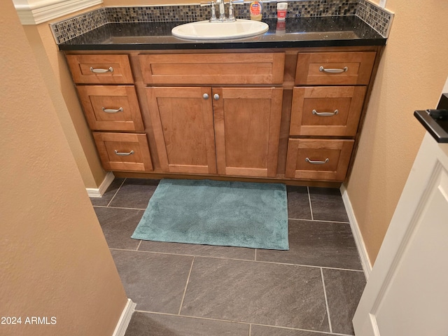 bathroom with tile flooring and vanity