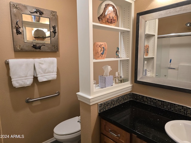 bathroom featuring toilet and vanity