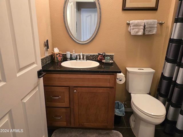 bathroom featuring tile floors, toilet, and vanity