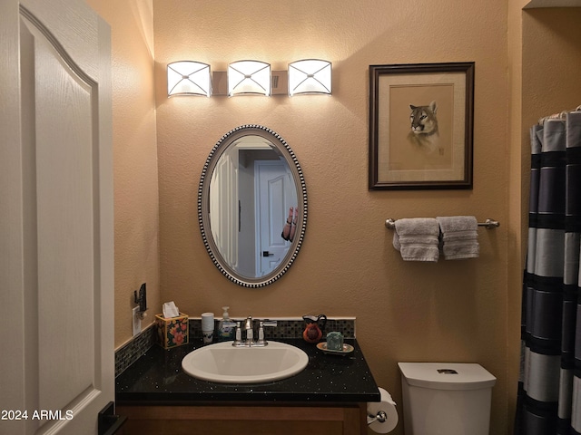 bathroom with toilet and oversized vanity