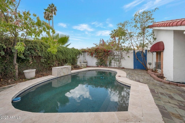 view of pool featuring a patio, a fenced in pool, and fence