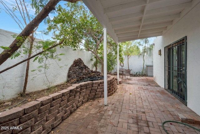 view of patio featuring fence