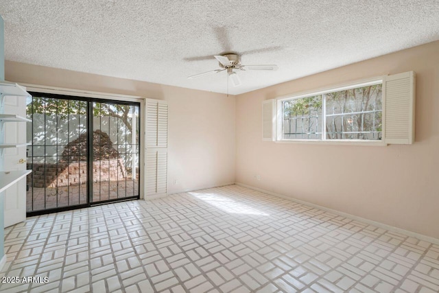 empty room with brick floor, baseboards, a textured ceiling, and a ceiling fan