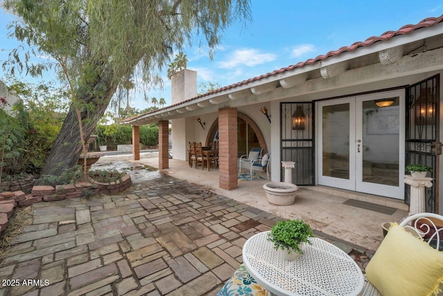 view of patio featuring outdoor dining area and french doors