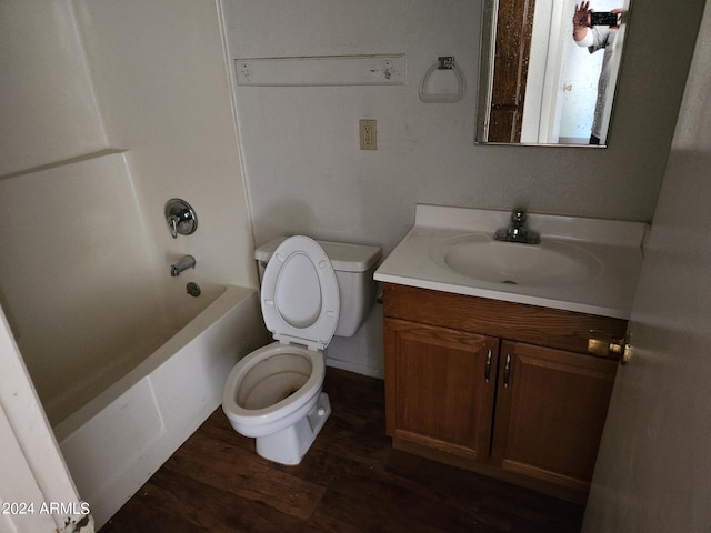 full bathroom featuring hardwood / wood-style floors, vanity, toilet, and shower / bath combination