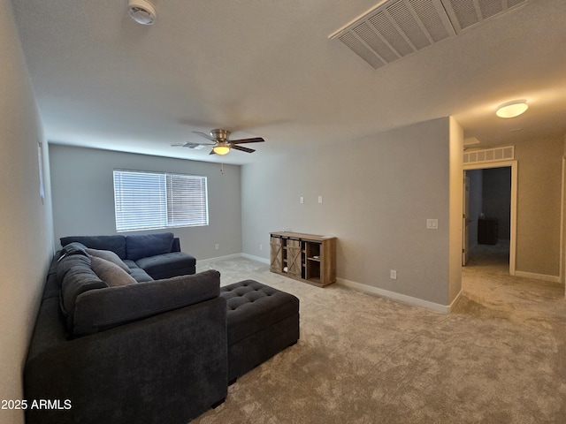 carpeted living room with visible vents, ceiling fan, and baseboards