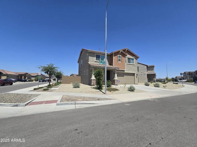 view of front of property featuring an attached garage, a residential view, concrete driveway, and stucco siding